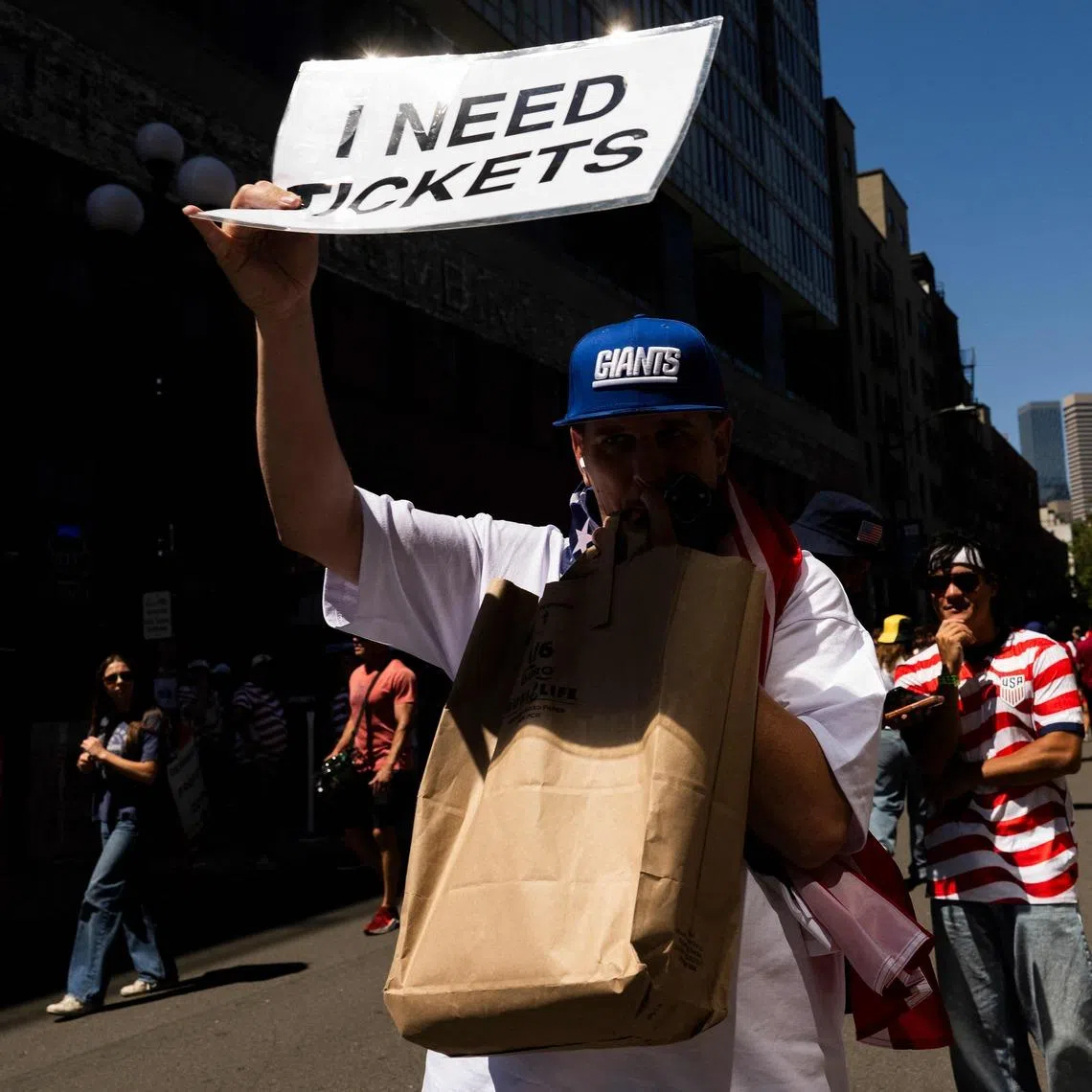 A fan asks for tickets before the round-of-16 match between USA and Belgium on July 6.