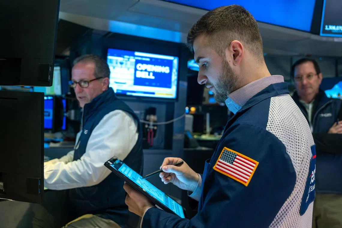 Traders work on the floor during morning trading at the New York Stock Exchange.
