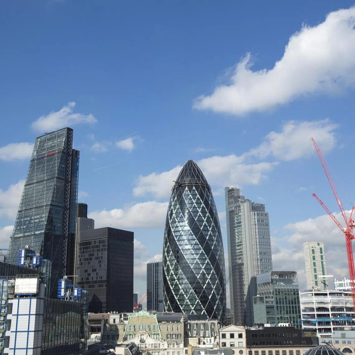 Skyscrapers including the Leadenhall building, also known as the "Cheesegrater", left, and 30 St Mary Axe, also known as "the Gherkin", center, stand surrounded by commercial office buildings in the City of London, U.K., on Wednesday, Feb. 24, 2016. The U.K. currency has tumbled this year amid concern that Britain will vote to leave the European Union, hampering trading and discouraging foreign investment. Photographer: Jason Alden/Bloomberg