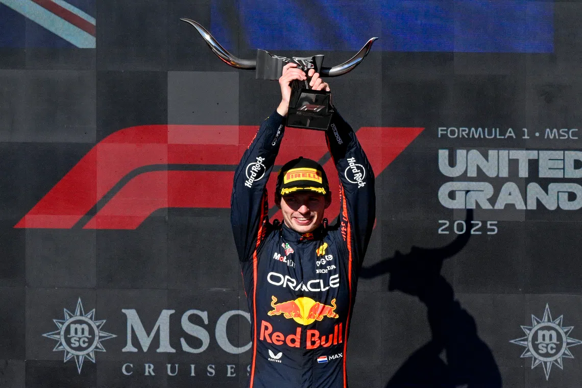 Oct 19, 2025; Austin, TX, USA; Oracle Red Bull Racing driver Max Verstappen (1) of Team Netherlands raises his trophy after winning the 2025 US Grand Prix at Circuit of The Americas Austin. Mandatory Credit: Jerome Miron-Imagn Images