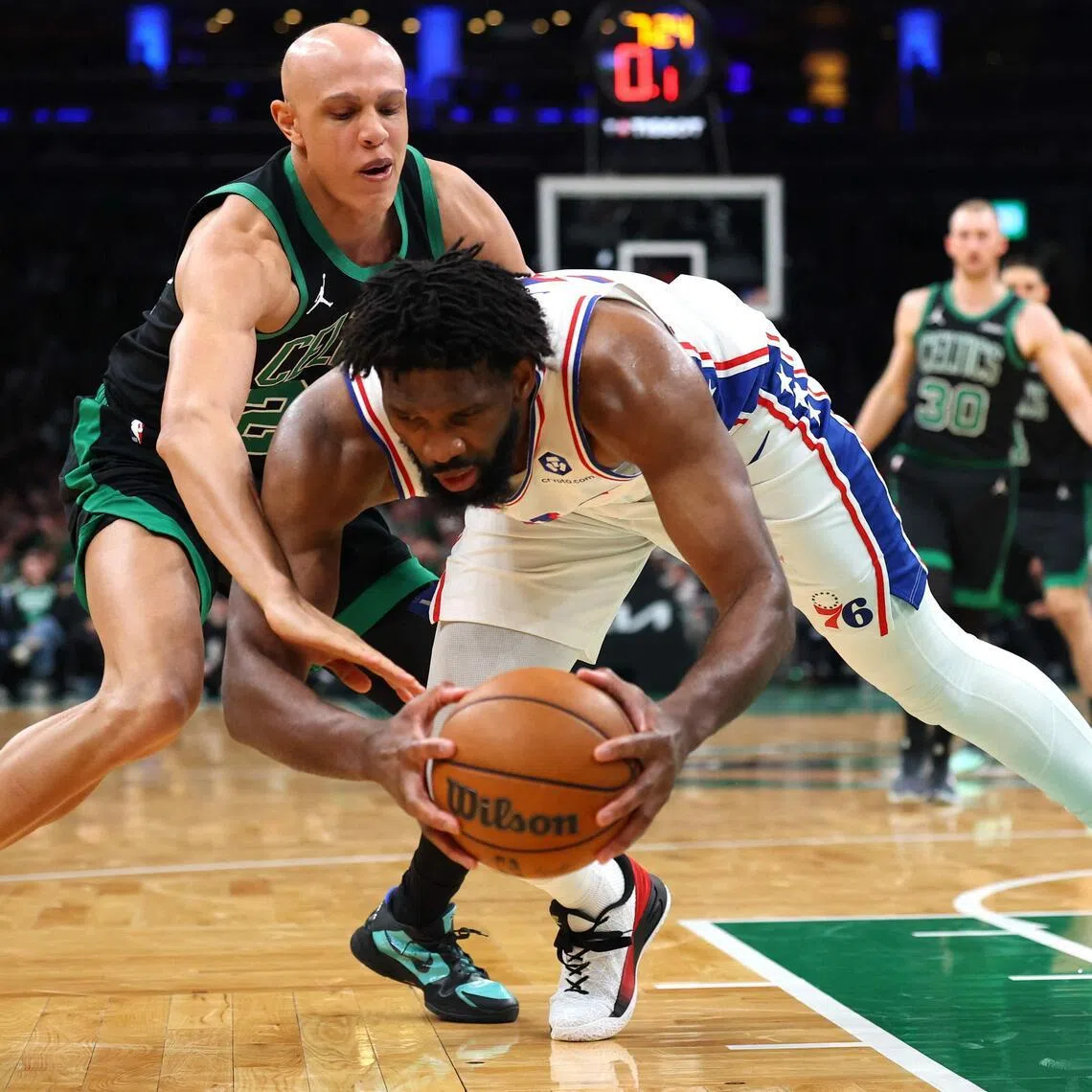 Joel Embiid of the Philadelphia 76ers grabs a loose ball in front of Jordan Walsh of the Boston Celtics during the third quarter in Game 5.