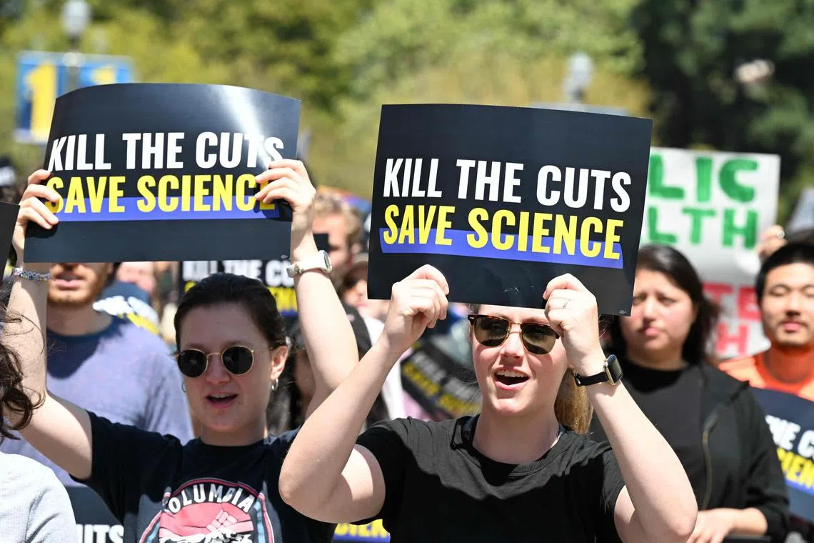 (FILES) UCLA students, researchers and demonstrators rally during a "Kill the Cuts" protest against the Trump administration's funding cuts on research, health and higher education at the University of California Los Angeles (UCLA) in Los Angeles on April 8, 2025. From cancer cures to climate change, President Donald Trump's administration has upended the American research landscape, threatening the United States' standing as a global science leader and sowing fear over jobs and funding. Mass layoffs at renowned federal agencies. Billions in research grants slashed. Open threats against universities. Bans on words linked to gender and human-caused global warming — all within the first 100 days. (Photo by Robyn Beck / AFP)