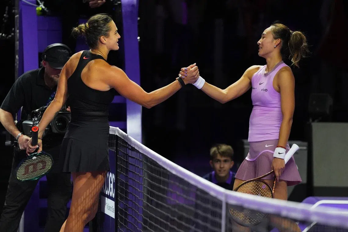 Tennis - WTA Finals - King Saud University Indoor Arena, Riyadh, Saudi Arabia - November 2, 2024 Belarus' Aryna Sabalenka shakes hands with China's Qinwen Zheng after winning their women's singles group stage match REUTERS/Aleksandra Szmigiel