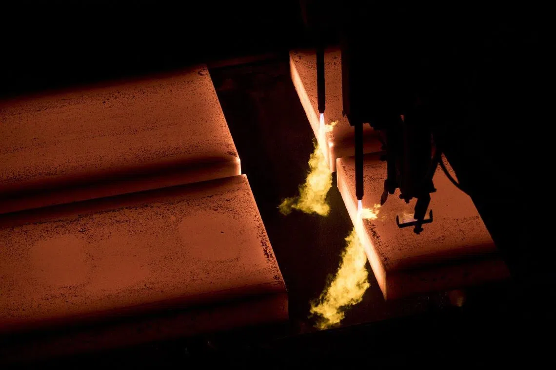 Slabs of steel separated by heat at BlueScope Steel Ltd. Port Kembla steelworks in Port Kembla, Australia, on Friday, Feb. 9, 2024. The world’s two biggest miners, BHP Group Ltd. and Rio Tinto Group, are teaming up in a bid to develop Australia’s first electric-smelting furnace, in what could prove an important step toward slashing emissions in the steel-making process. Photographer: Brent Lewin/Bloomberg
