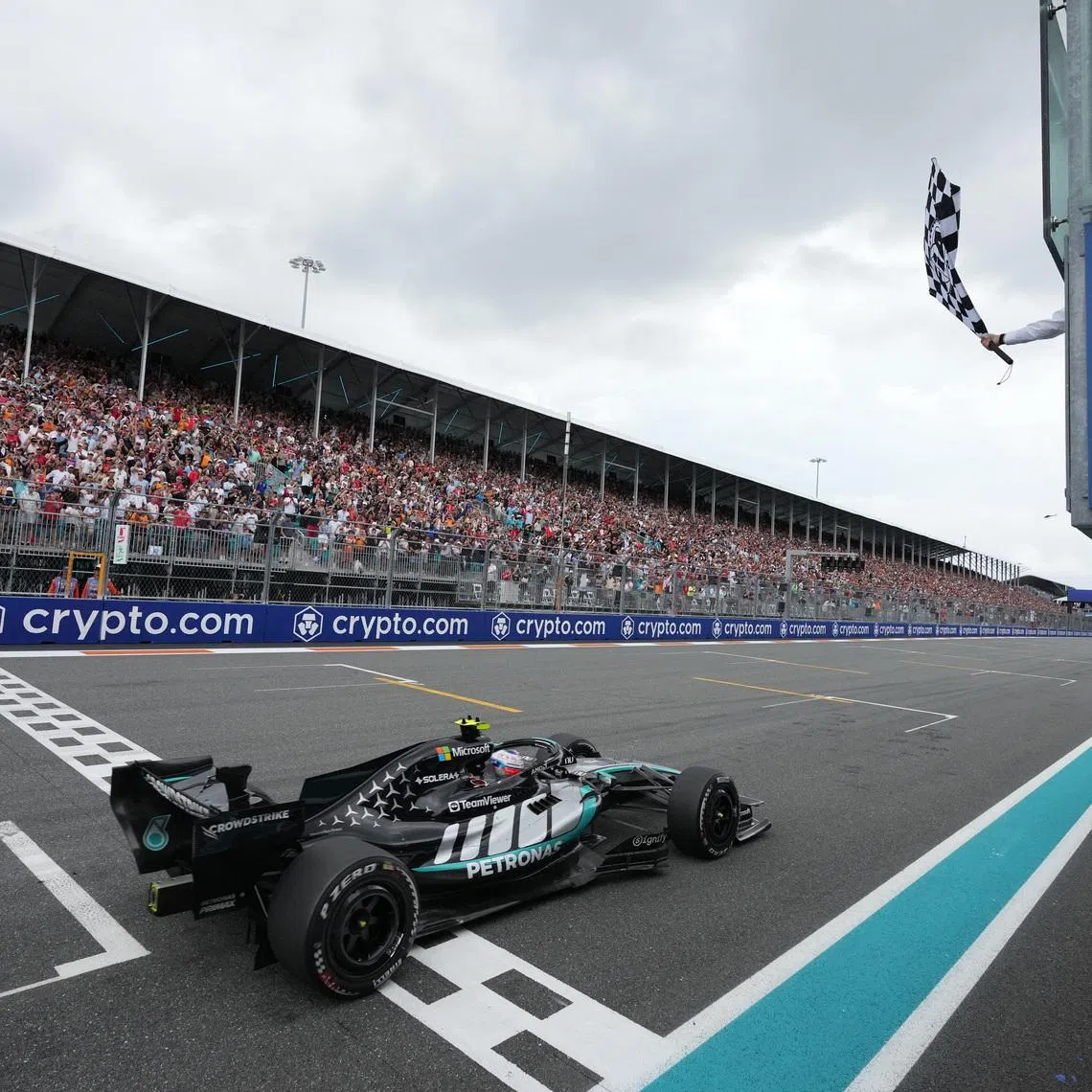Formula One F1 - Miami Grand Prix - Miami International Autodrome, Miami, Florida, United States - May 3, 2026 Mercedes' Andrea Kimi Antonelli passes the chequered flag waved by former tennis player Rafael Nadal to win the Miami Grand Prix Pool via Reuters/Rebecca Blackwell