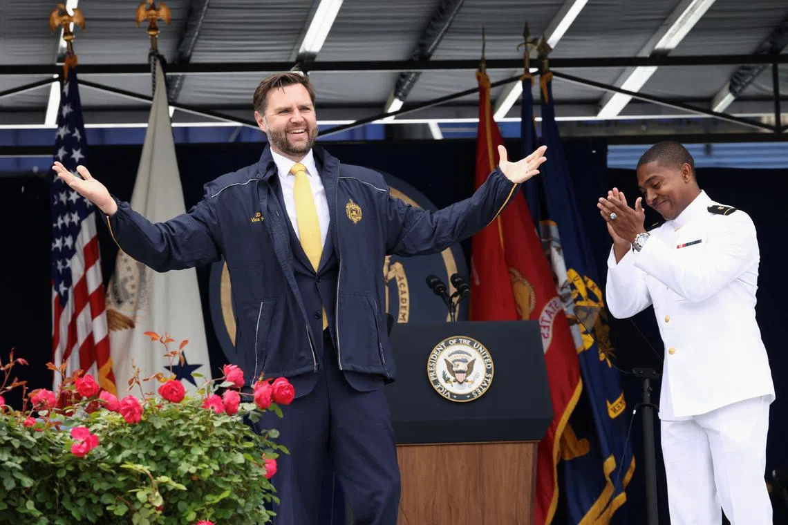 U.S. Vice President JD Vance receives a jacket as a gift after speaking at the Graduation and Commissioning Ceremony at the U.S. Naval Academy in Annapolis, Maryland, U.S., May 23, 2025. REUTERS/Kevin Lamarque