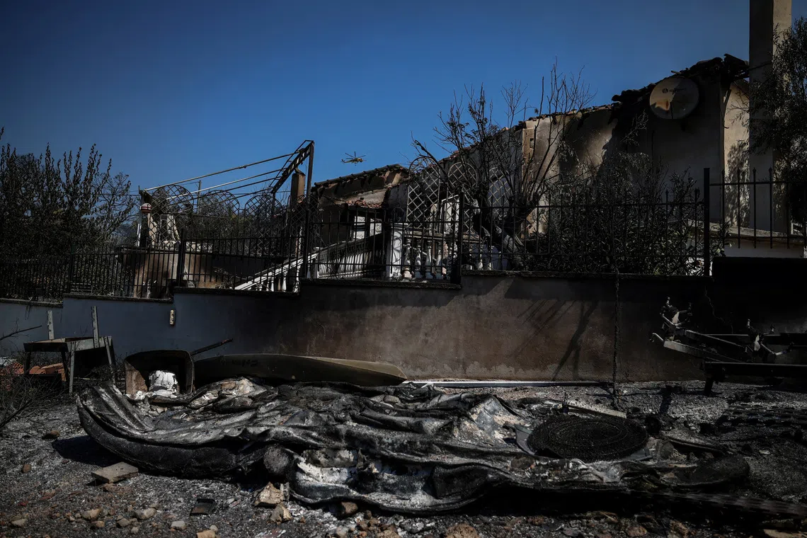 A house burned down by wildfires in Psatha, Greece, on Aug 4.