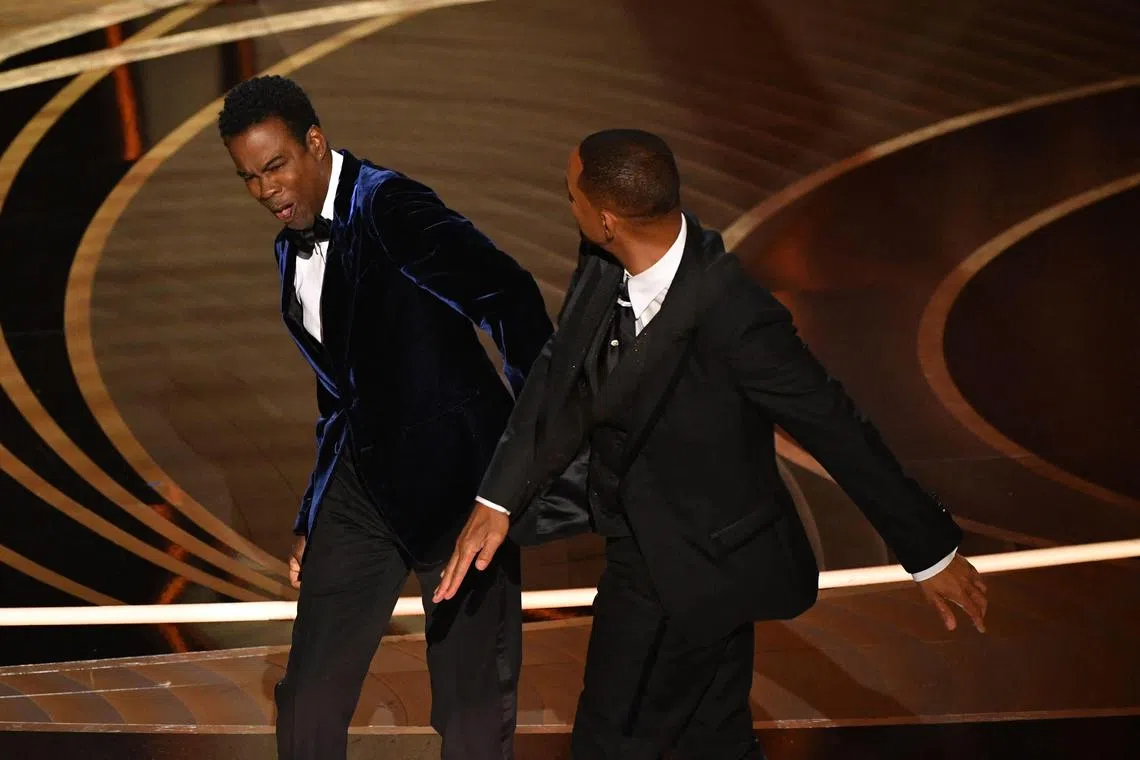 Will Smith (right) slapping Chris Rock onstage during the 94th Oscars in March 2022.