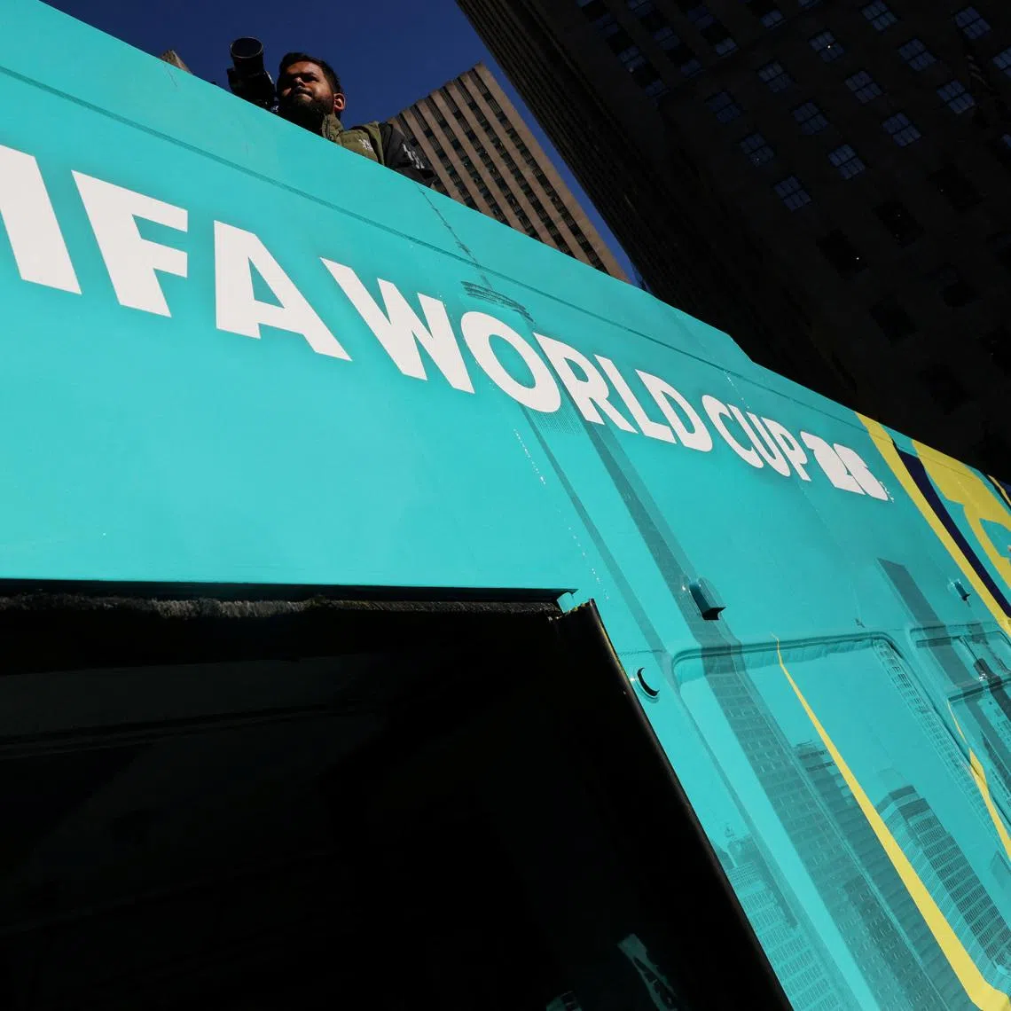 A bus advertisement for FIFA World Cup 26 New York and New Jersey at Rockefeller Center in New York City.