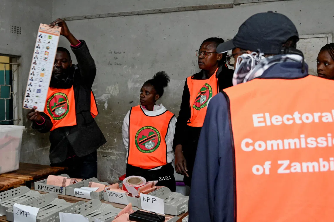 FILE PHOTO: An election official displays a ballot paper as observers look on during the counting of votes after the polls closed at a polling station in Lusaka, Zambia, during Zambia's general elections, including the presidential election, August 13, 2026. REUTERS/Moses Mwape/File Photo