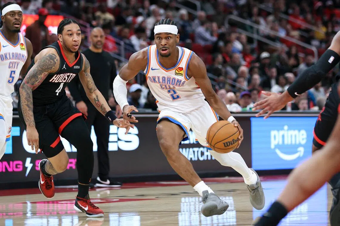 Oklahoma City Thunder guard Shai Gilgeous-Alexander dribbles the ball as Houston Rockets guard JD Davison defends during the third quarter at Toyota Center on Jan 15.