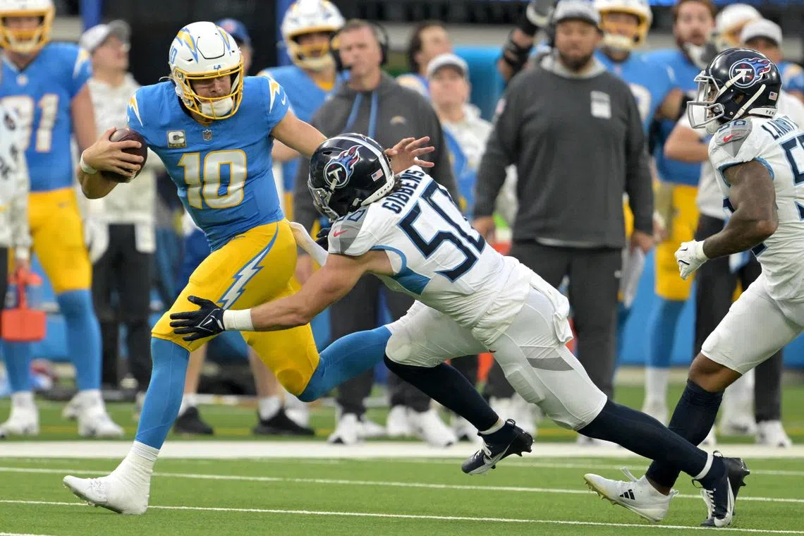 Nov 10, 2024; Inglewood, California, USA;  Los Angeles Chargers quarterback Justin Herbert (10) runs for a first down before he is stopped by Tennessee Titans linebacker Jack Gibbens (50) in the second half at SoFi Stadium. Mandatory Credit: Jayne Kamin-Oncea-Imagn Images/ File Photo