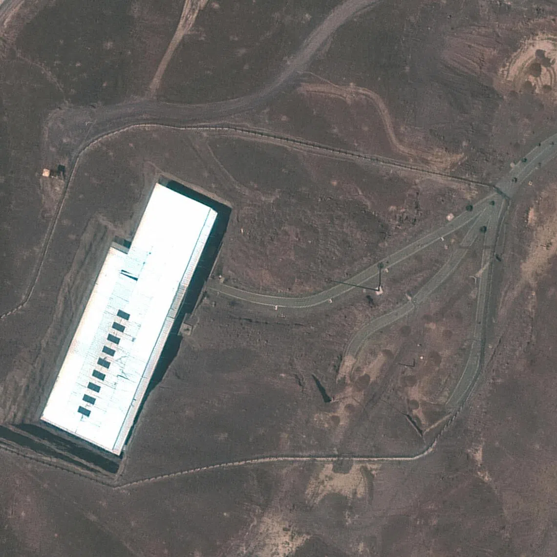 A satellite view showing an overview of Iran’s Fordow underground enrichment plant, with obstacles on a road, near Qom, Iran, on June 21.