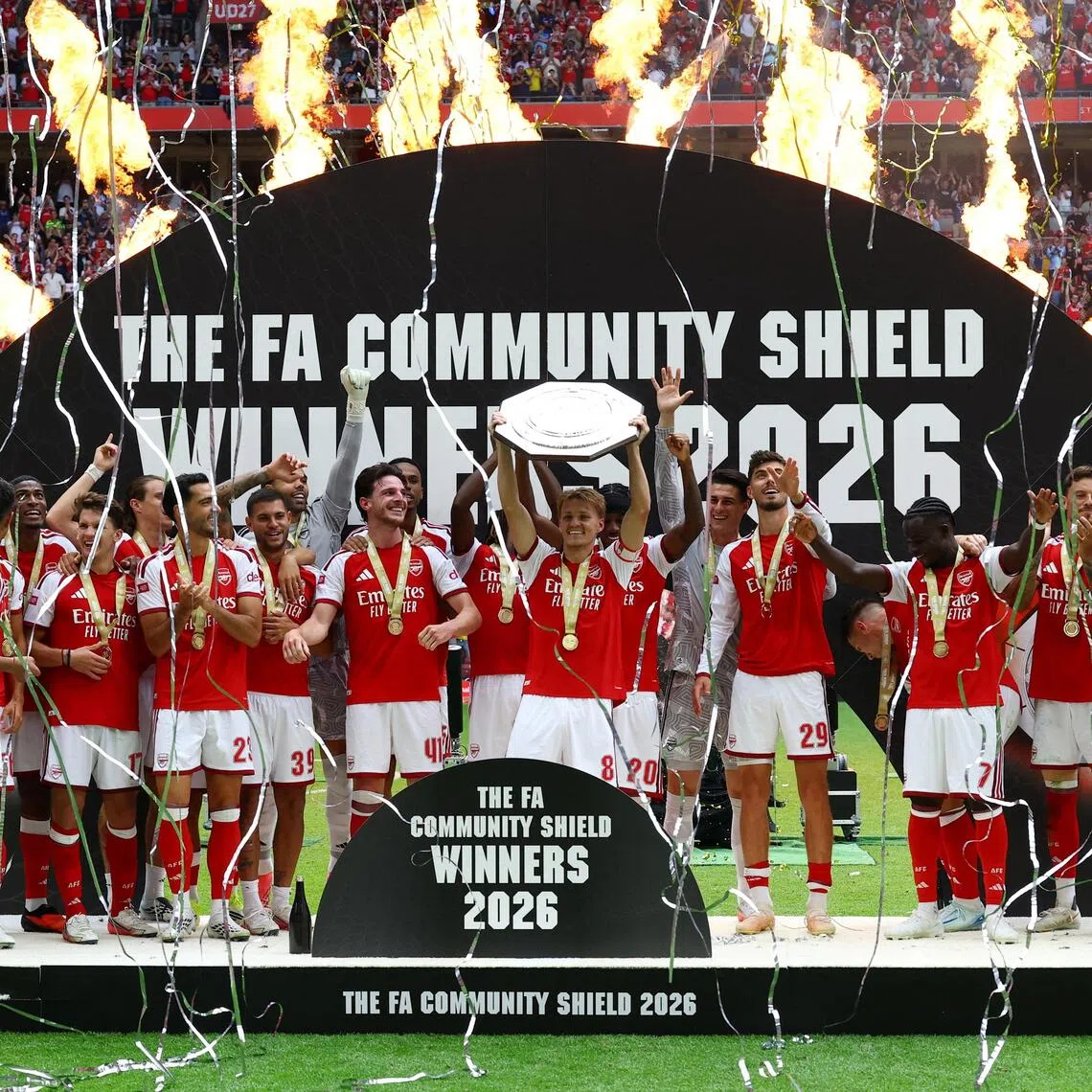 Arsenal’s Martin Odegaard lifting the trophy as the team celebrates winning the FA Community Shield on Aug 16.