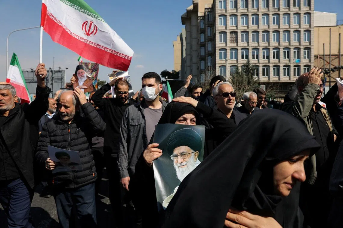 A demonstrator holds an image of Iran's late Supreme Leader Ayatollah Ali Khamenei, after he was killed in Israeli and U.S. strikes on Saturday, during an anti-Israeli and U.S. rally after Friday prayer, amid the U.S.-Israeli conflict with Iran, in Tehran, Iran, March 6, 2026. Majid Asgaripour/WANA (West Asia News Agency) via REUTERS