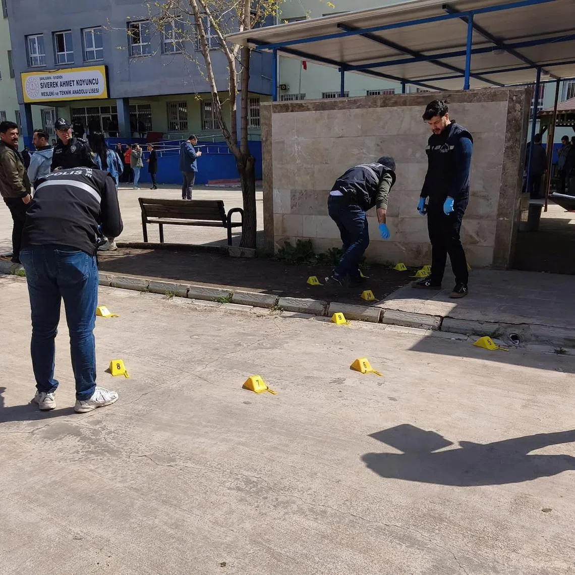 Forensic police officers search the site after a teenager opened fire at a school and wounded at least 16 people, including students and teachers, before killing himself in Siverek, Sanliurfa province, Turkey, April 14, 2026. REUTERS/Sukru Dolas
