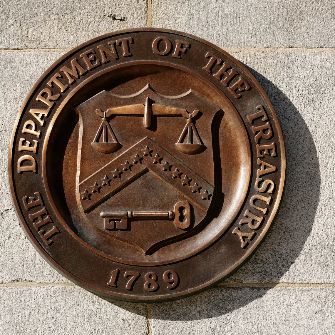 FILE PHOTO: A bronze seal for the Department of the Treasury is shown at the U.S. Treasury building in Washington, U.S., January 20, 2023. REUTERS/Kevin Lamarque/File Photo
