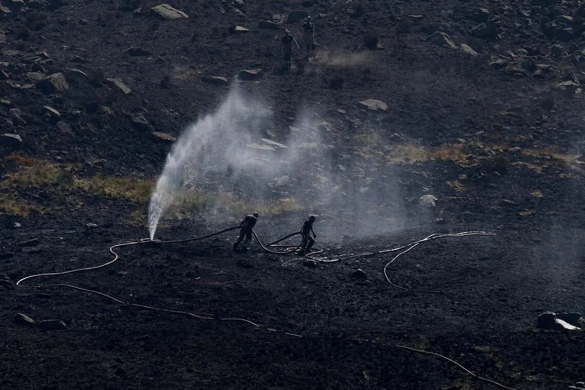 Firefighters fight a moorland blaze near the Dovestone Reservoir in Manchester, Britain, July 13, 2026. REUTERS/Temilade Adelaja TPX IMAGES OF THE DAY