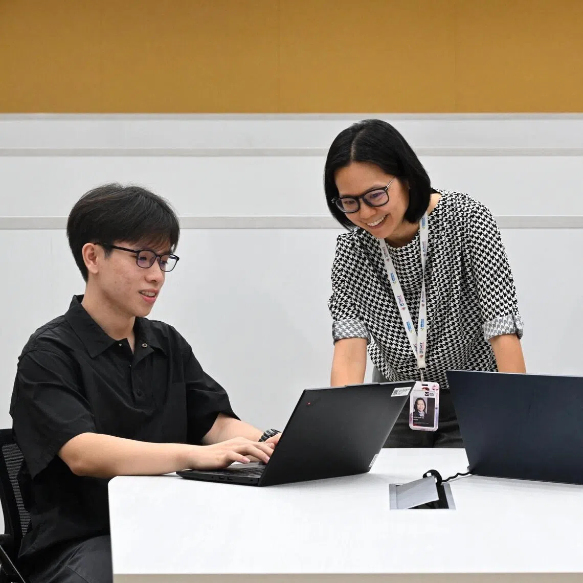 Associate Professor Wong Shin Yee, programme leader for SIT’s Bachelor of Food Technology with Honours programme (centre) with her students Lief Chng Han Wei, 26 (right) and Jason Goh Jie Sheng, 24, as they do their assessment with the chat bots.
