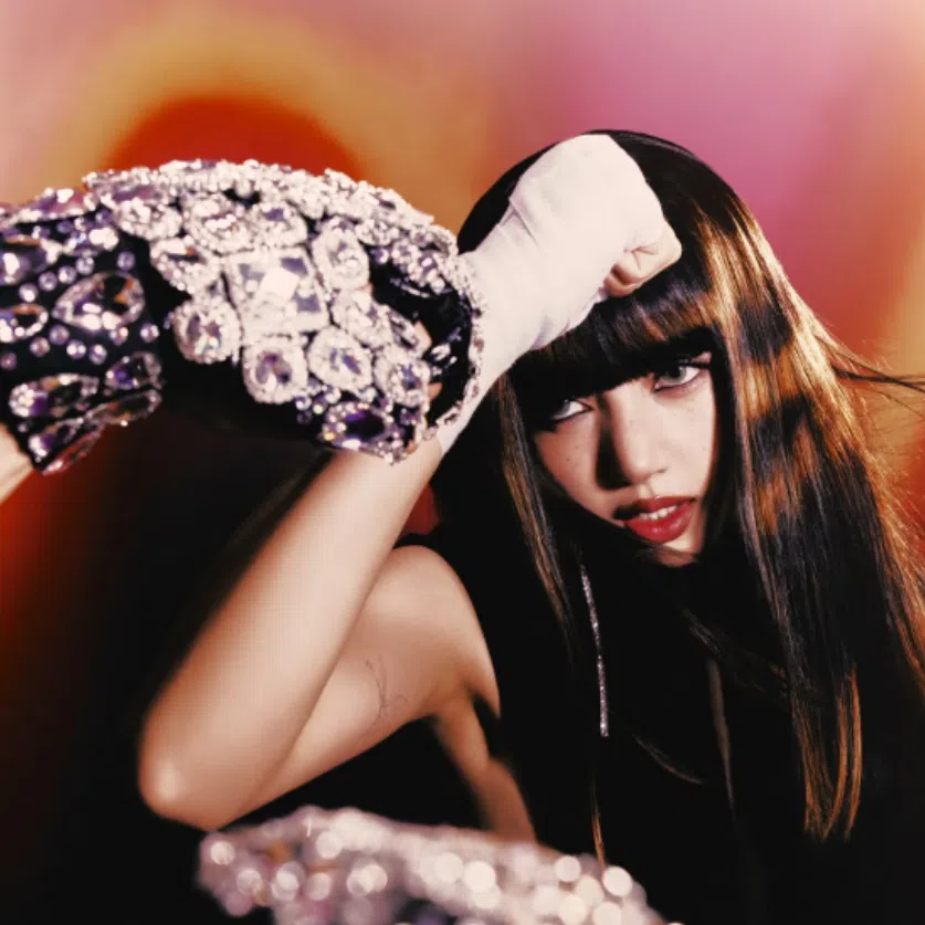 Newly released images show Lisa in a contemporary take on Muay Thai attire, including boxing shorts with “LISA” embroidered prominently across the waistband.