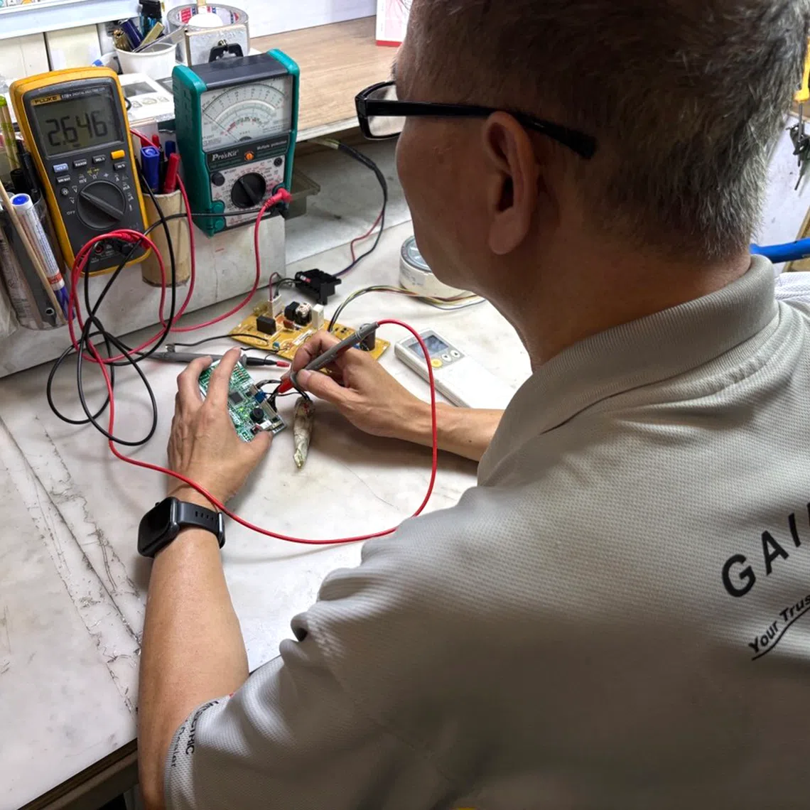 Gain City’s repair specialists checking whether faulty appliances can be given a second life. It is running a free repair clinic for eligible electrical appliances in October at its Sungei Kadut megastore.