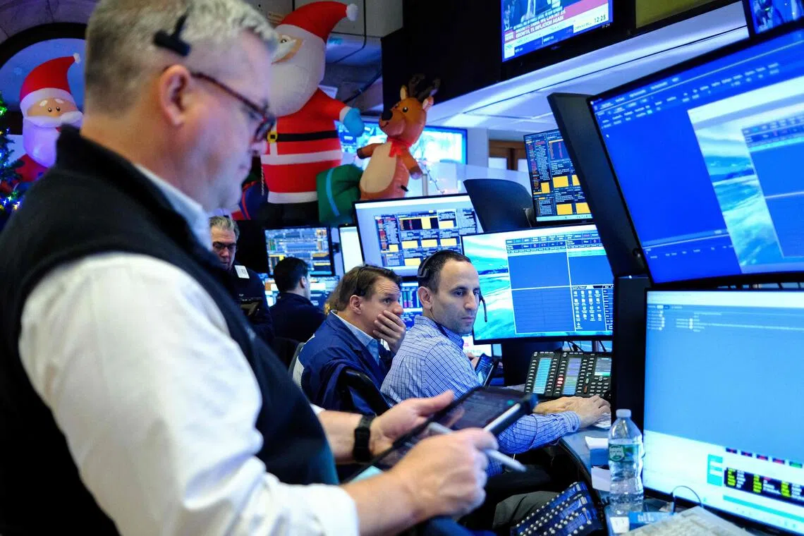 Traders working on the floor of the New York Stock Exchange at the opening bell, in New York on Dec 16.