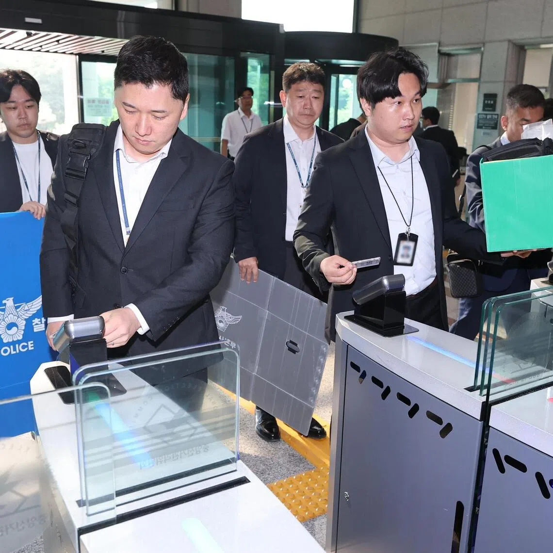 Police investigators enter the National Election Commission headquarters in Gwacheon, South Korea, on June 11.