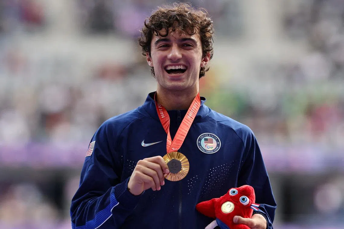 FILE PHOTO: Paris 2024 Paralympics - Athletics - Men's High Jump - T63 Victory Ceremony - Stade de France, Saint-Denis, France - September 4, 2024 Gold medallist Ezra Frech of the United States celebrates with his medal on the podium REUTERS/Umit Bektas/File Photo
