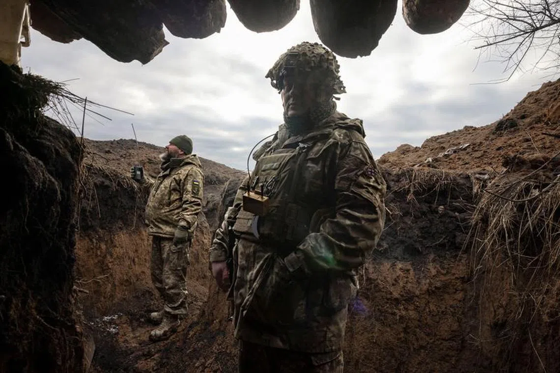Ukrainian military engineers stand in a freshly dug trench that their unit built as part of a system of new fortifications near the front lines outside Kupiansk, amid Russia’s attack on Ukraine, December 28, 2023.  REUTERS/Thomas Peter/ File Photo