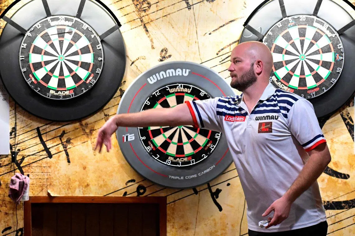 French professional darts player Thibault Tricole, nicknamed "the French touch", takes part in a training session in Malguenac.