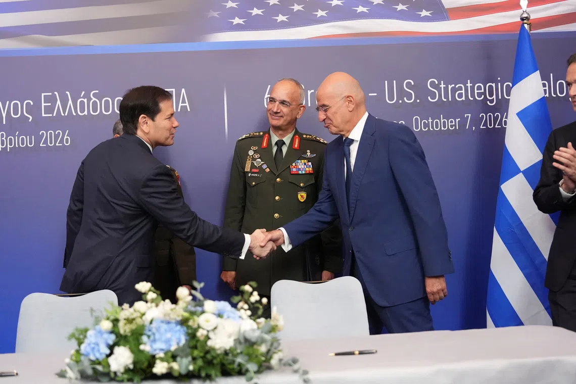 U.S. Secretary of State Marco Rubio,  shakes hands with Greek Defense Minister Nikos Dendias as Gen. Dimitrios Choupis, chief of the Hellenic National Defence General Staff, looks on  during a signing ceremony at the Conrad Hotel in Athens, Greece October 7, 2026.   Mark Schiefelbein/Pool via REUTERS