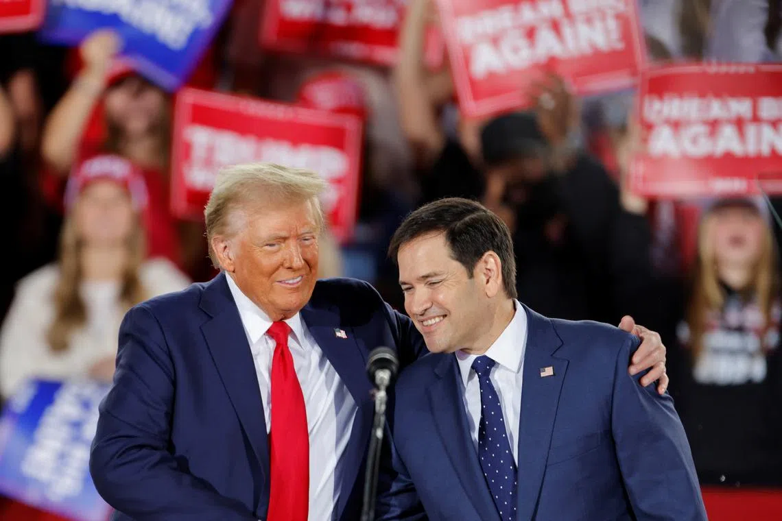 FILE PHOTO: Donald Trump and Senator Marco Rubio (R-FL) react during a campaign event at Dorton Arena, in Raleigh, North Carolina, U.S. November 4, 2024. REUTERS/Jonathan Drake/File Photo