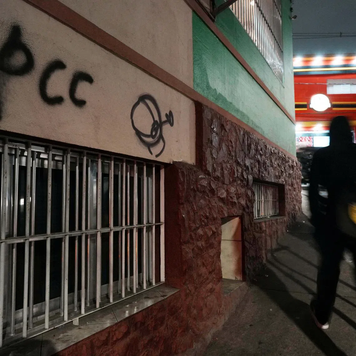 FILE PHOTO: People walk past a sign reading \"PCC\", referring to Brazilian drug gang Primeiro Comando da Capital, after U.S. Secretary of State Marco Rubio announced a policy to designate \"PCC\" and Comando Vermelho \"CV\" as foreign \"terrorist organizations\", in Sao Paulo, Brazil, May 29, 2026. REUTERS/Alexandre Meneghini