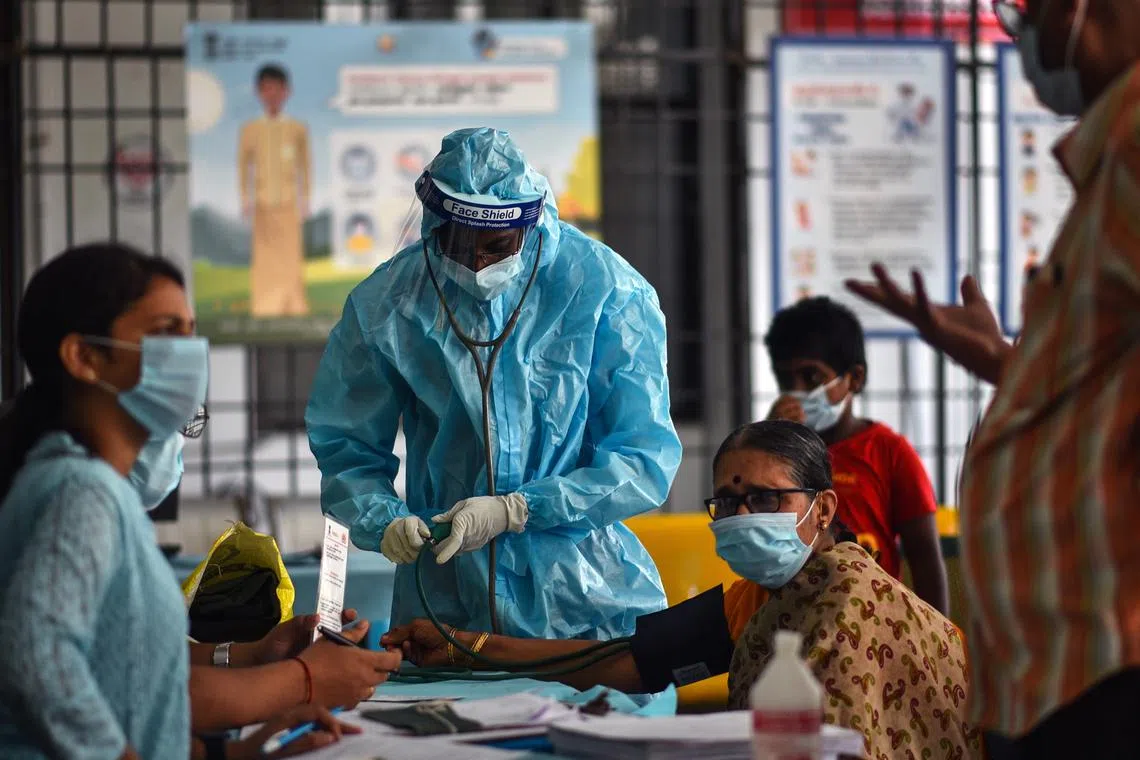 epa10379171 An Indian health worker wearing a Personal Protective Equipment (PPE) suit measures the blood pleasure of an elderly woman before administering a COVID-19 vaccine, at Omandurar government hospital, in Chennai, India, 27 December 2022. In the wake of growing concern about the coronavirus around the world, hospitals across India carried out a mock drill to check the preparedness and evaluate the health facilities such as the capacity of isolation beds, oxygen-supported beds, and ICU (intensive care unit) beds. The central government has asked the states to be on alert during the ongoing festival season to deal with any spike in COVID-19 cases.  EPA-EFE/IDREES MOHAMMED