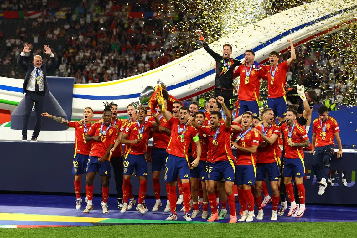 Soccer Football - Euro 2024 - Final - Spain v England - Berlin Olympiastadion, Berlin, Germany - July 14, 2024 Spain's Alvaro Morata lifts the trophy as they celebrate after victory REUTERS/Kai Pfaffenbach