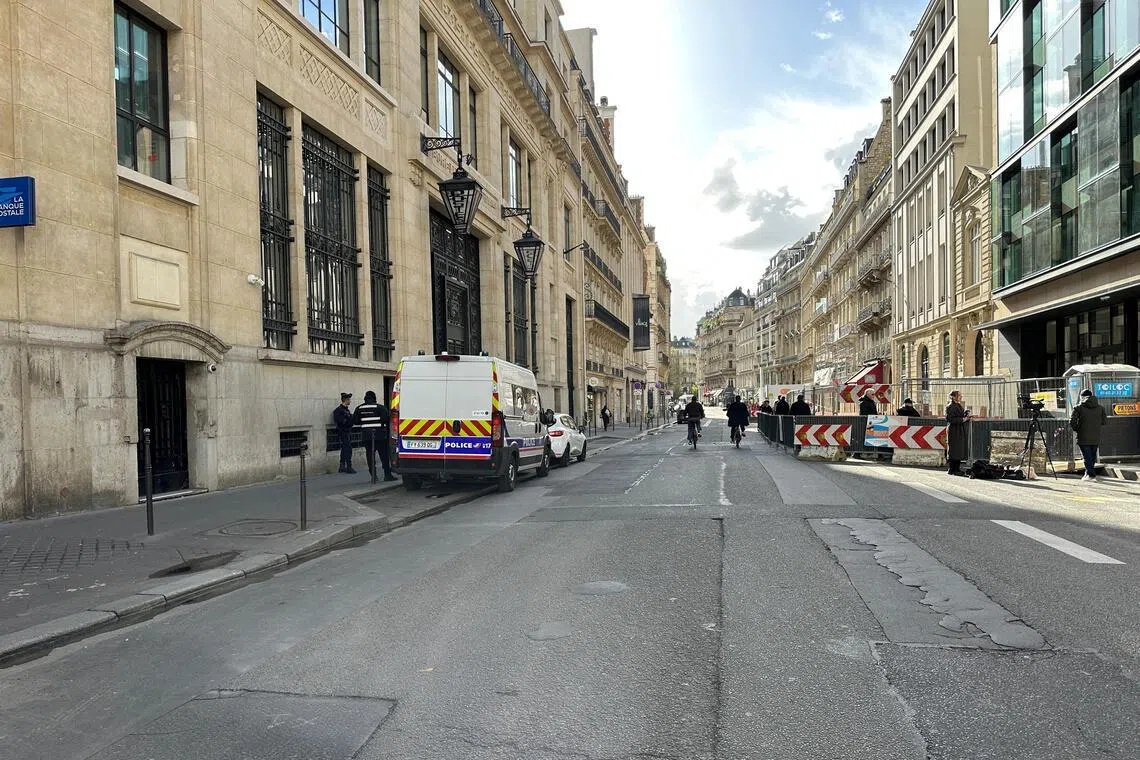 Police and private security vehicles outside the Bank of America building in the 8th arrondissement of Paris on March 28, following an apparent bomb attack attempt.