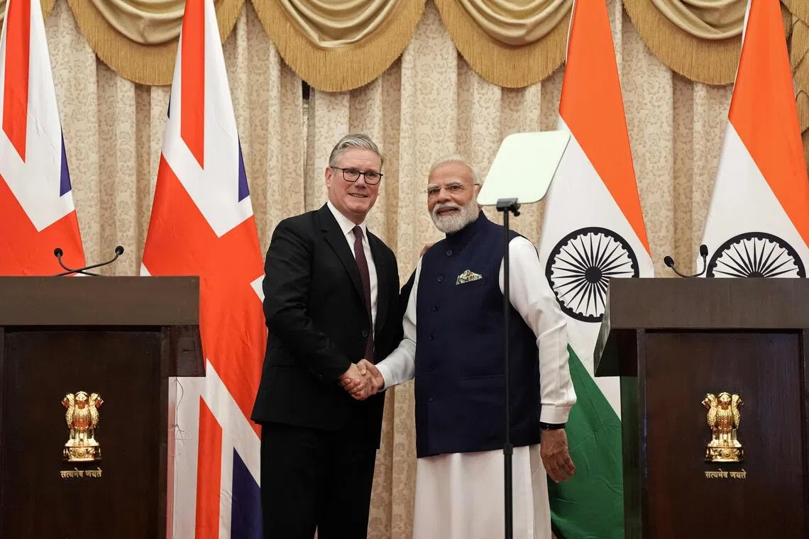 Britain's Prime Minister Keir Starmer (left) shakes hands with his Indian counterpart Narendra Modi during a joint press conference after their bilateral meeting in Mumbai on Oct 9, 2025.