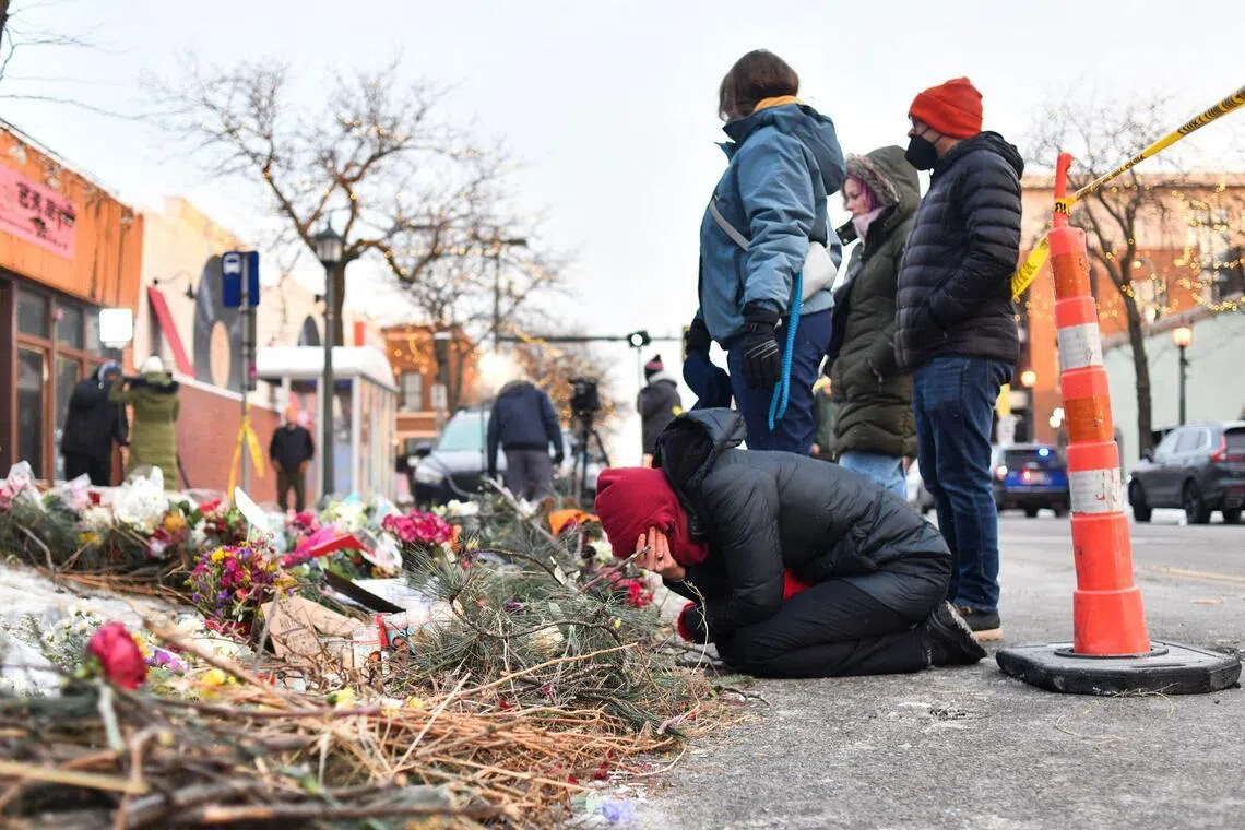 Mourners gather at a makeshift memorial in the area where Mr Alex Pretti was shot dead a day earlier by federal immigration agents in Minneapolis, Minnesota.
