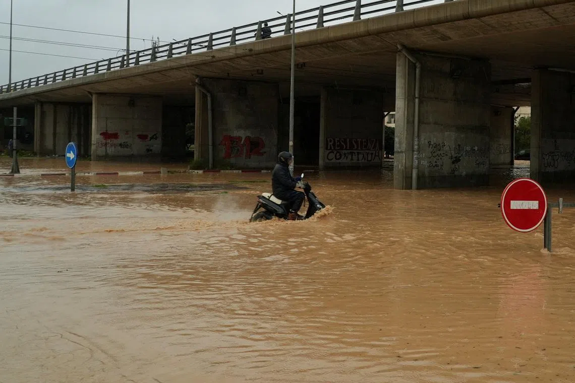 A person rides a motorcycle through a flooded street as torrential rains hit the country, in Tunis, Tunisia January 20, 2026. REUTERS/Jihed Abidellaoui