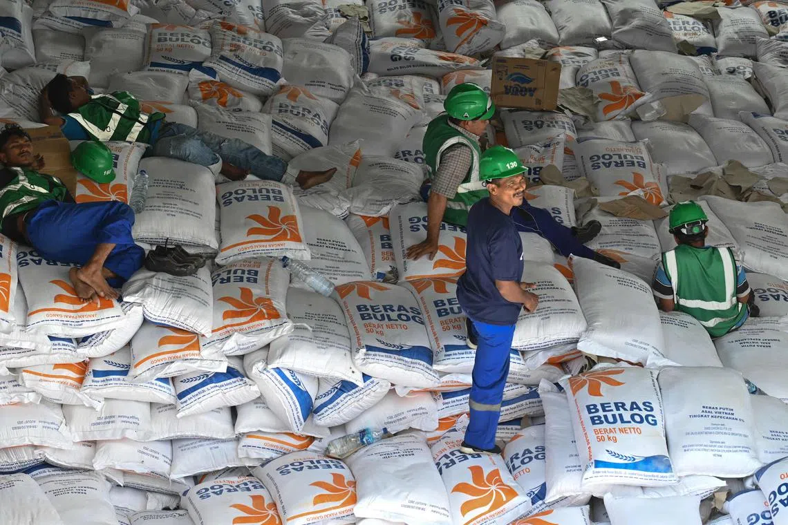 Workers unloading rice from Vietnam in Aceh province on Oct 11. Indonesia is importing 2 million tonnes of rice to cover a shortage.