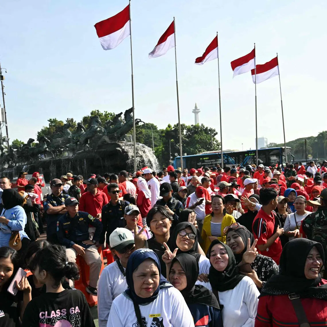 A crowd of well-wishers gather outside the Presidential Palace as they wait for the inauguration of Indonesia's president-elect Prabowo Subianto in Jakarta on October 20, 2024. Prabowo Subianto will be sworn in October 20 as president of the world's third-largest democracy, Indonesia, with the wealthy ex-general accused of rights abuses taking over eight months after a landslide election win. (Photo by JUNI KRISWANTO / AFP)