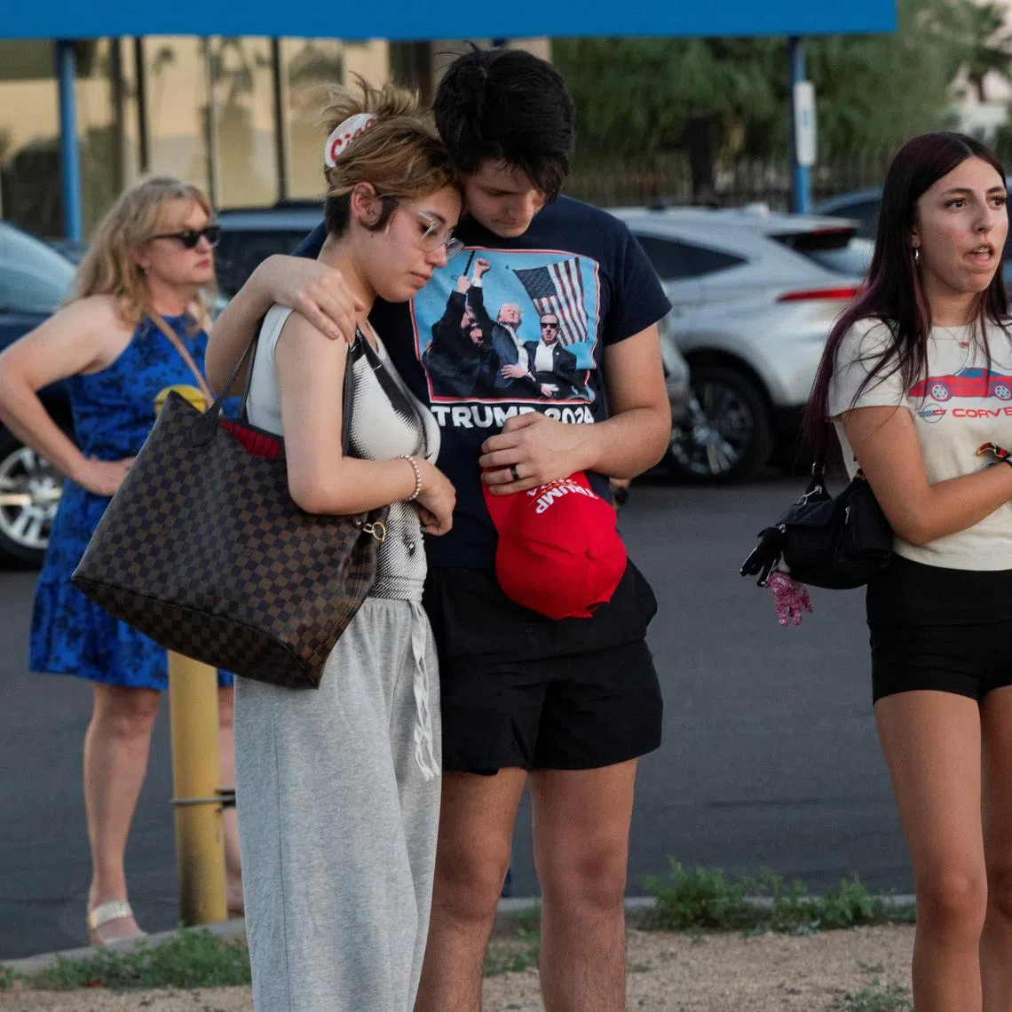 People react as they gather outside the mortuary where the body of slain conservative activist Charlie Kirk was delivered, in Phoenix, Arizona, U.S., September 11, 2025, one day after Kirk was fatally shot during an event at Utah Valley University. REUTERS/Thomas Machowicz