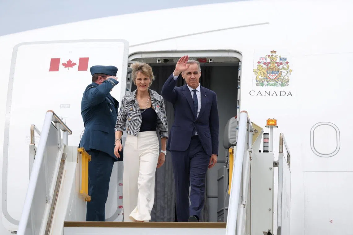 Canadian Prime Minister Mark Carney and his wife Diana Fox Carney arrive at Sydney Kingsford Smith Airport in Sydney, Australia, March 3, 2026. REUTERS/Hollie Adams
