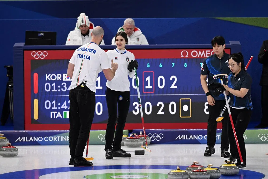Milano Cortina 2026 Olympics - Curling - Mixed Doubles Round Robin Session 2 - South Korea vs Italy - Cortina Curling Olympic Stadium, Cortina d'Ampezzo, Italy - February 05, 2026. Stefania Constantini of Italy and Amos Mosaner of Italy celebrate winning their match against Seonyeong Kim of South Korea and Yeongseok Jeong of South Korea REUTERS/Jennifer Lorenzini