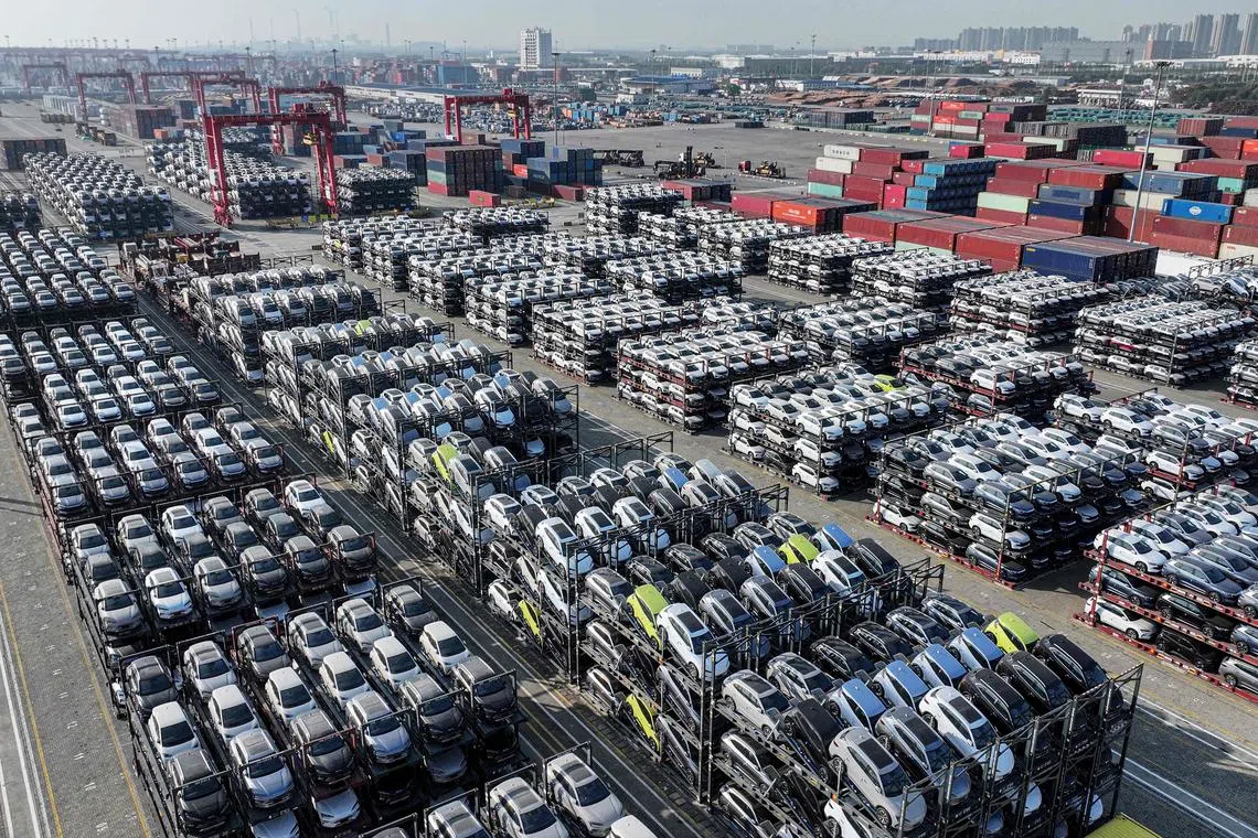 This aerial view shows BYD electric cars that will be exported to South America stacked at the Taicang Port in Suzhou, in China’s eastern Jiangsu province on April 8, 2025. (Photo by STRINGER / AFP) / China OUT