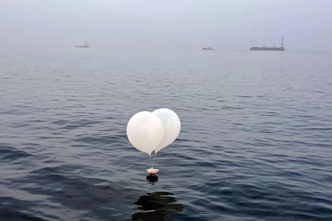 A balloon carrying various objects including what appeared to be trash, believed to have been sent by North Korea, is pictured at the sea off Incheon, South Korea, June 9, 2024.    Yonhap via REUTERS