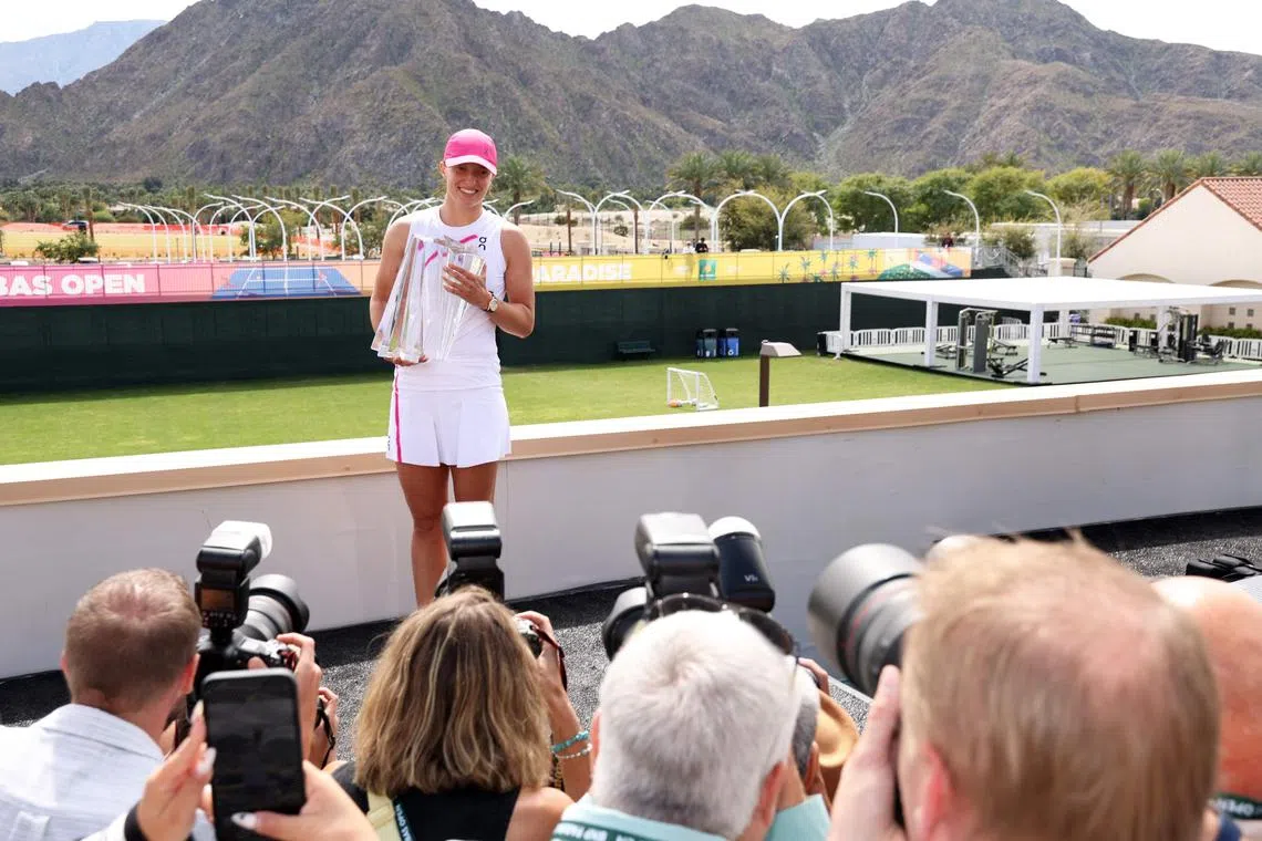 Poland's Iga Swiatek poses with the trophy after winning the BNP Paribas Open at Indian Wells.