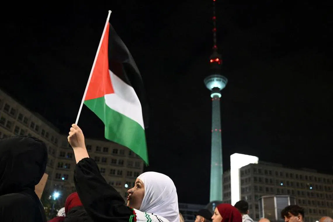 File photo: A woman waves a Palestinian flag during a pro-Palestinian assembly at Alexanderplatz, amid the ongoing conflict between Israel and the Palestinian group Hamas, in Berlin, Germany, October 22, 2023. REUTERS/Annegret Hilse/File photo
