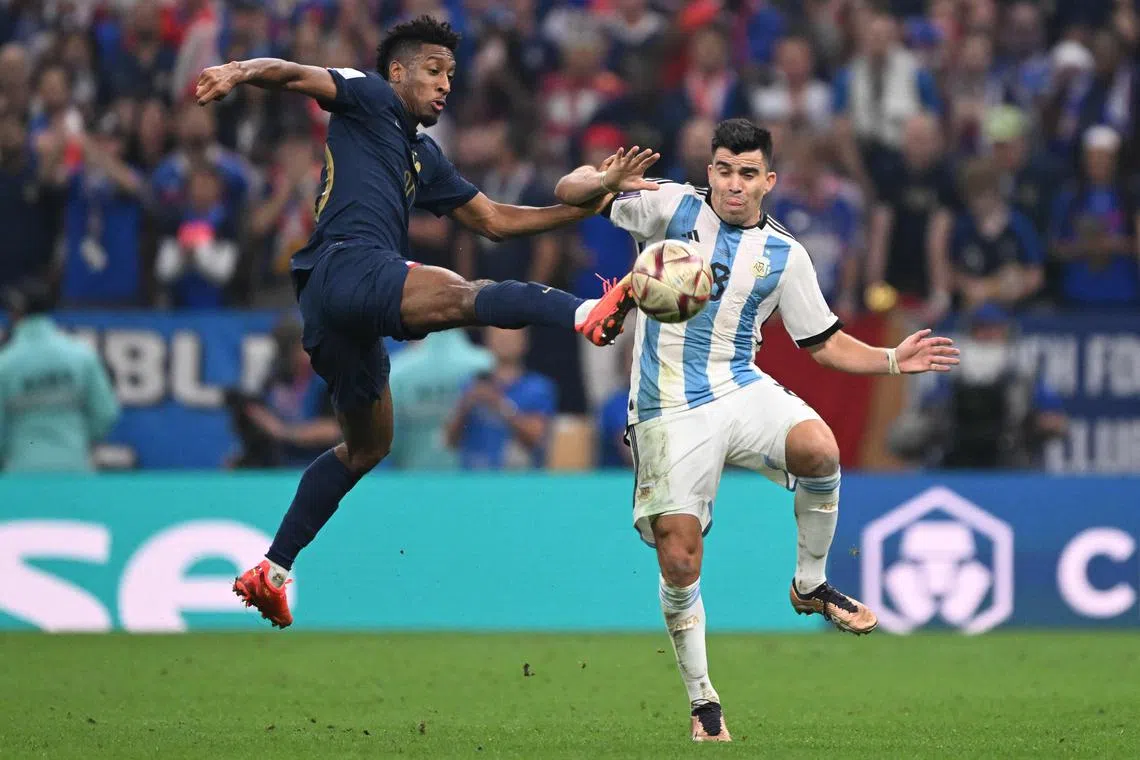 France forward Kingsley Coman fights for the ball with Argentina defender Marcos Acuna during the World Cup final.