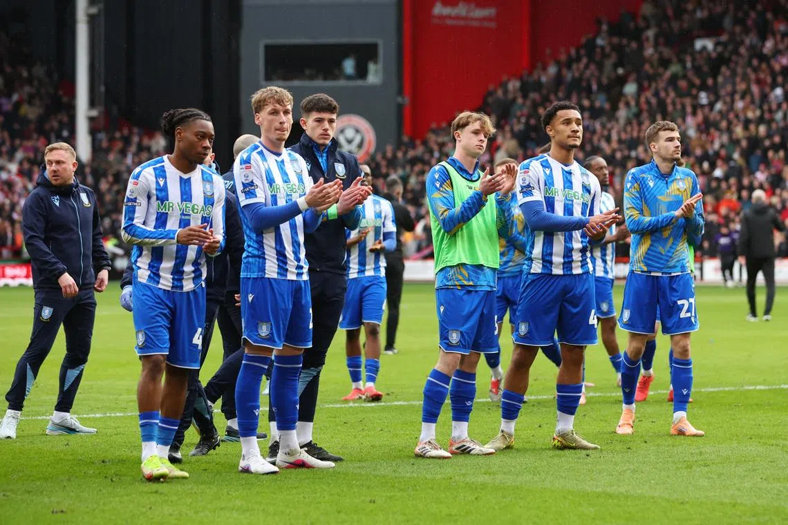 Soccer Football - Championship - Sheffield United v Sheffield Wednesday - Bramall Lane, Sheffield, Britain - February 22, 2026 Sheffield Wednesday players look dejected after the match as they are relegated from the Championship Action Images/Craig Brough